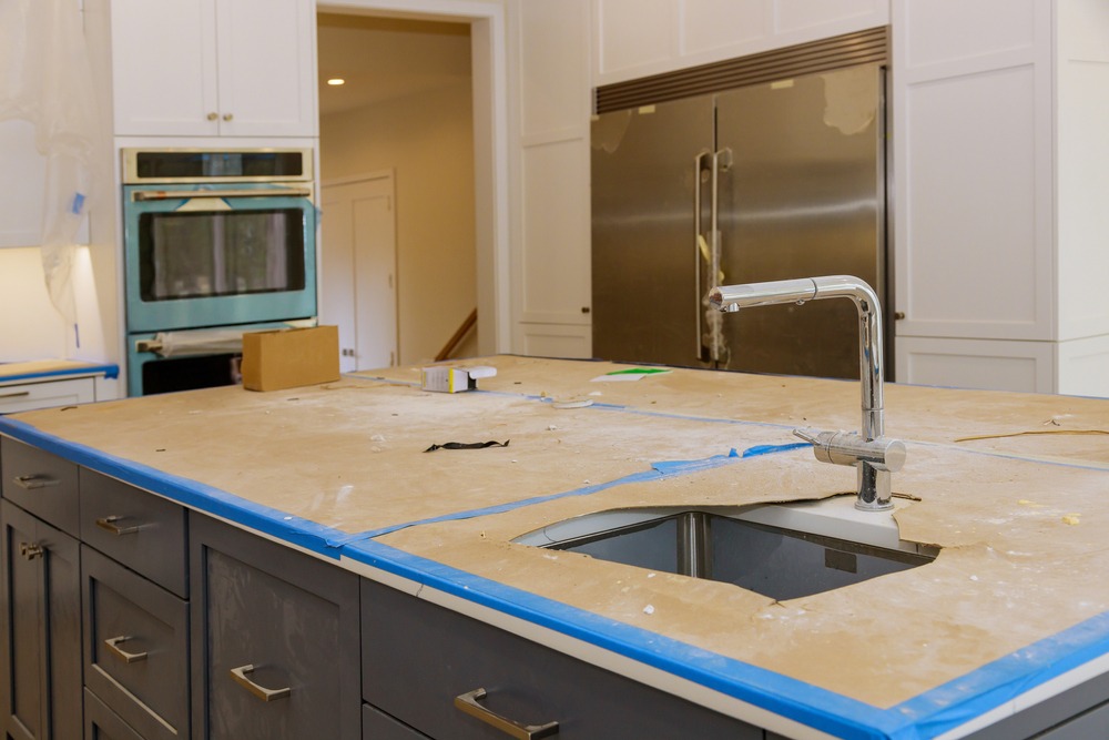 A kitchen with a sink and apparent ongoing construction work, suggesting renovation or remodeling
